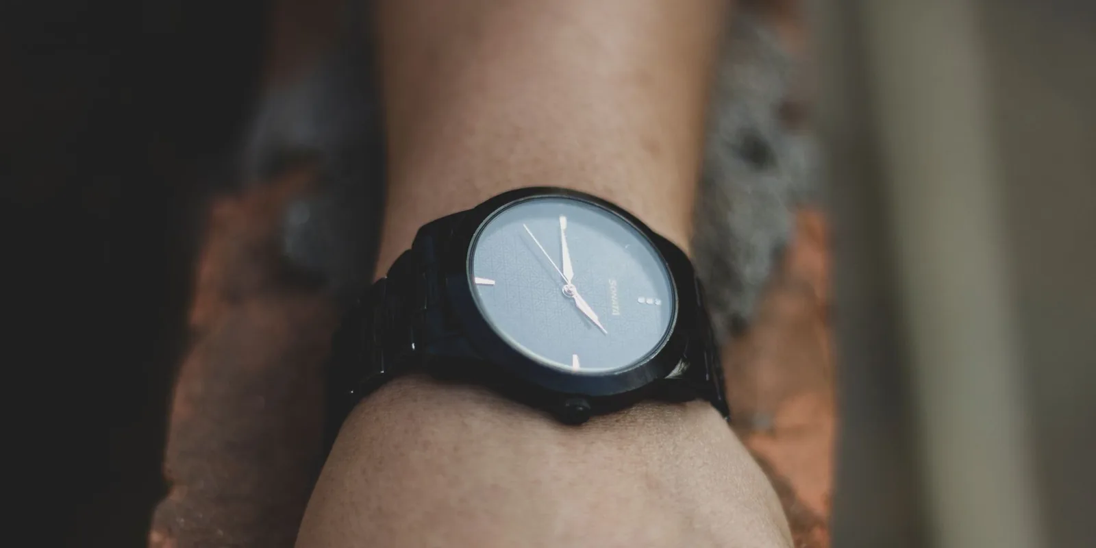 Minimalist black watch on wrist showcasing elegant design and precise timekeeping