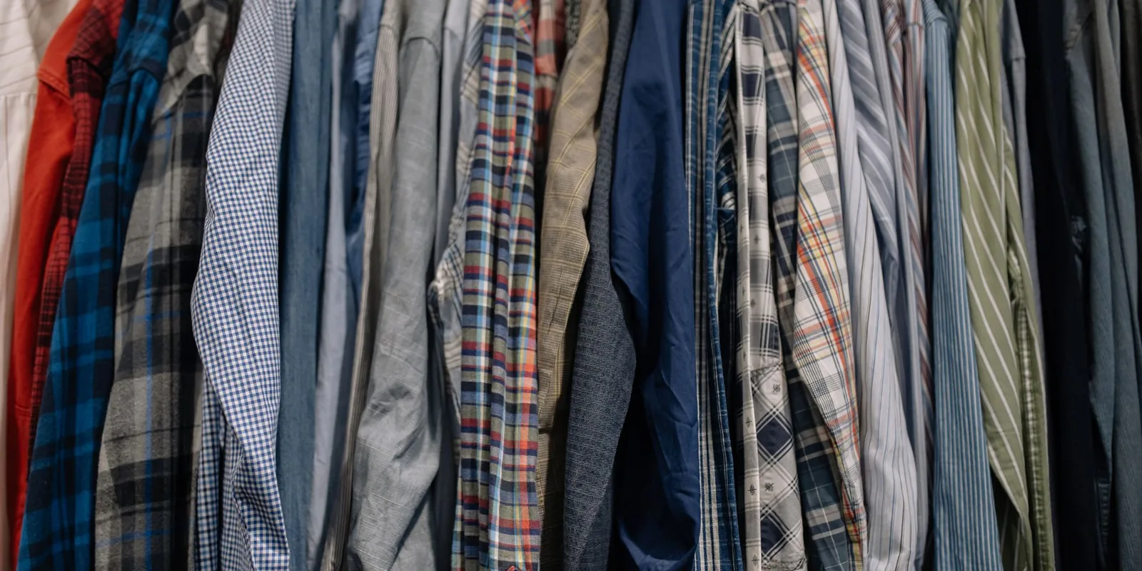 Assorted patterned shirts neatly arranged on a clothes rack
