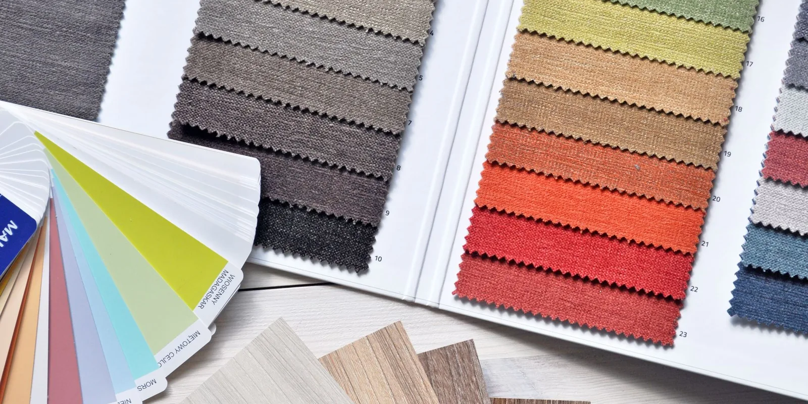 Colorful fabric and paint swatches laid out for design inspiration and material selection