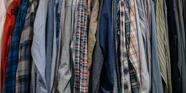 Assorted patterned shirts neatly arranged on a clothes rack