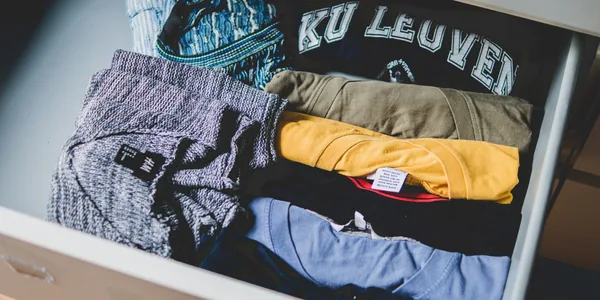 A neat arrangement of clothes and T-shirts in a drawer, showcasing casual wear