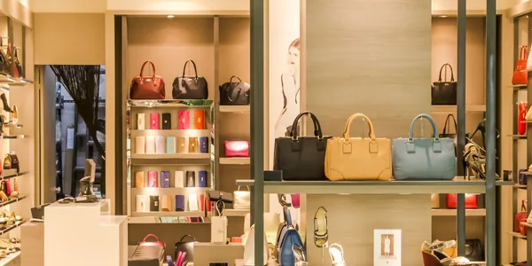 Chic boutique with a variety of handbags and shoes elegantly displayed on shelves