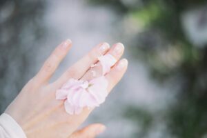 person with flower petals on back of hand