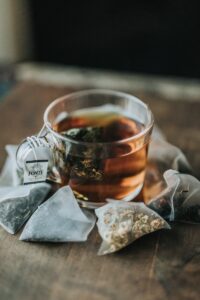 shallow focus photography cup of tea with teabags around the side