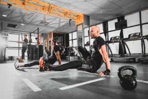 man in black top and black leggings doing exercise