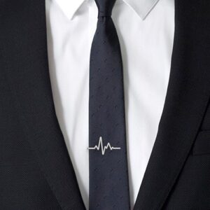 close up of a person wearing a suit with a tie pin