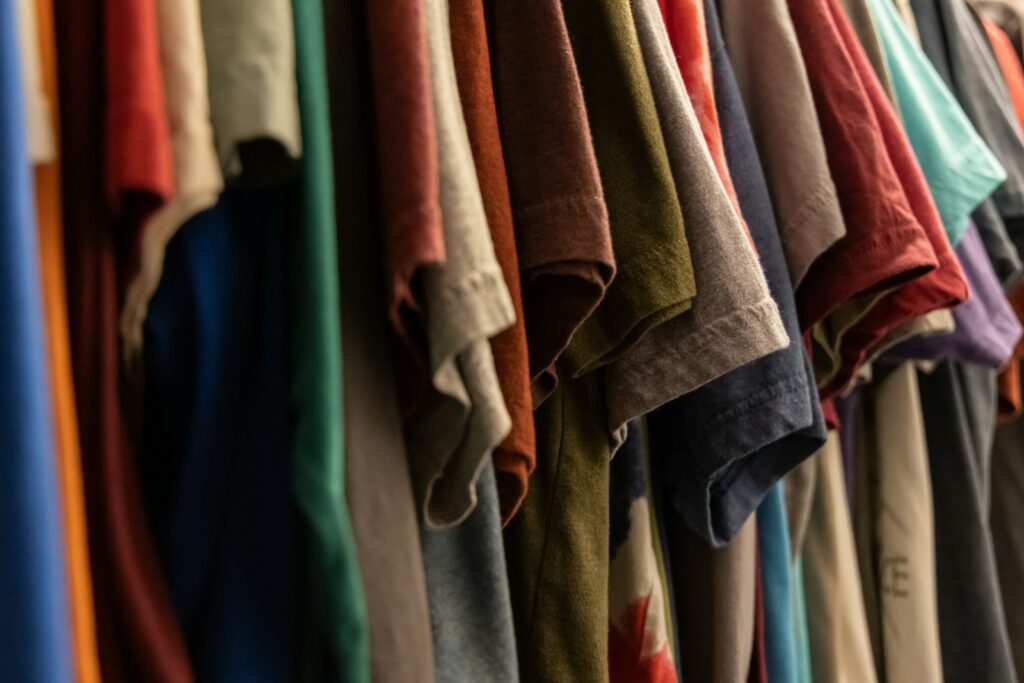 assorted t-shirts hanged on rack