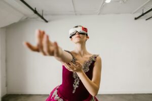 A woman in a pink dress wearing a virtual reality headset